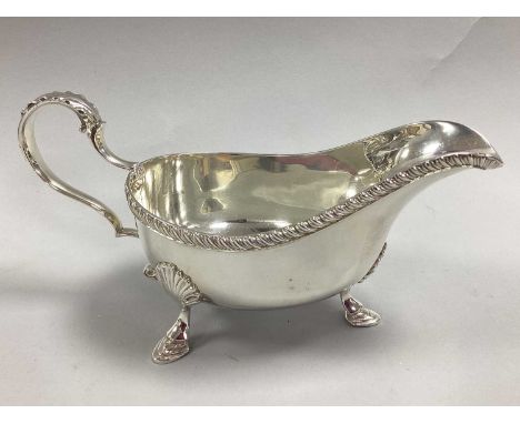 William Hutton &amp; Sons; A Hallmarked Silver Sauce Boat, Birmingham 1938, with decorative textured rim and leaf cap handle,