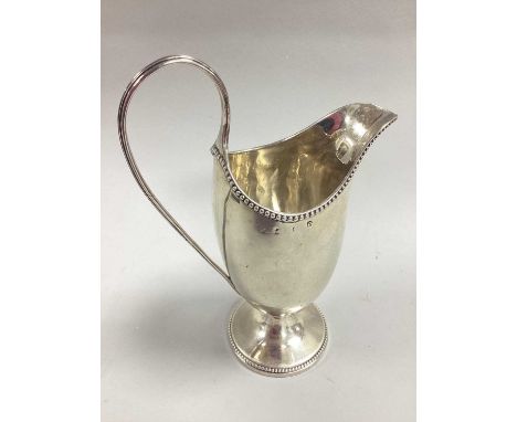  Georgian Hallmarked Silver Helmet Shape Cream Jug, (marks incomplete / rubbed) of plain form with beaded edge and reeded hig