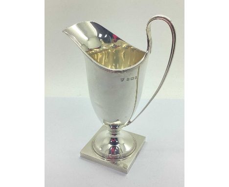 Ellis &amp; Co; A Hallmarked Silver Cream Jug, Birmingham 1934, of helmet form, of plain design with reeded rim and hangle, o