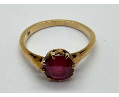 A Ruby Single Stone Ring, old cut, claw set between plain shoulders, stamped "18" (finger size O).