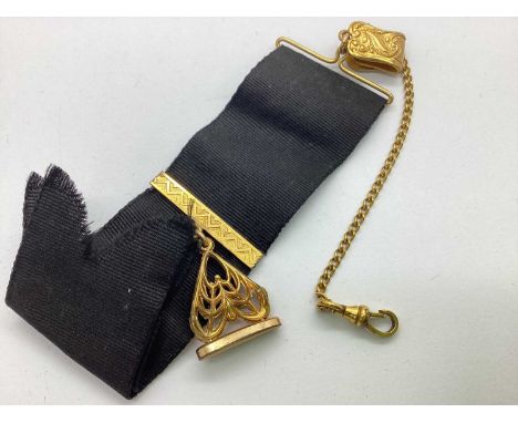 A Victorian Black Watch Ribbon, suspending gilt coloured decorative openwork seal fob, on gilt coloured mount, to similar sus