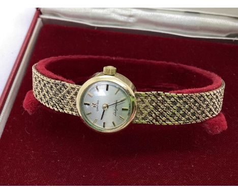 Omega; A 9ct Gold Cased Ladymatic Wristwatch, the signed dial with gilted baton markers, within circular plain case, to integ