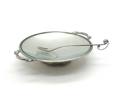 Georg Jensen; A Shallow Twin Handled Footed Dish, with plain glass liner, between stylised handles, raised on pierced rim bas