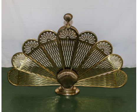 A folding brass fire screen