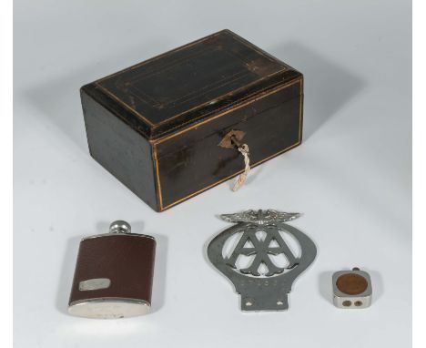 A small box together with a hip flask, cigarette lighter and an AA badge