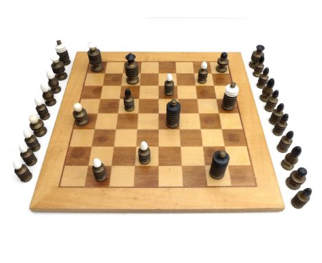 A modern brass chess set, the turned bodies with black and white plastic tops, king 9cm high, together with a wooden board, 5