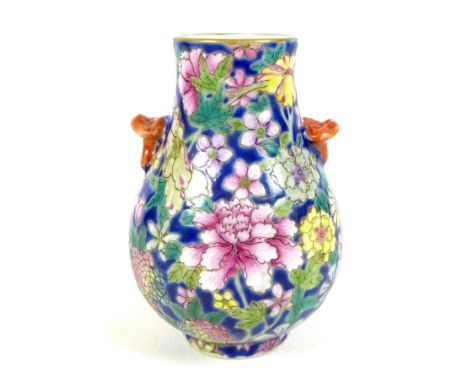 A small Chinese porcelain 'Hu' shaped vase, likely Republic period, decorated with a millefleurs design against a blue ground