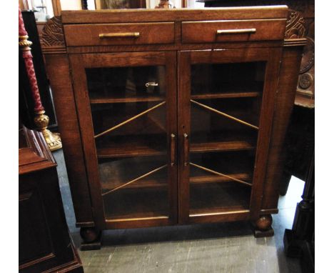 AN OAK ART DECO STYLE DISPLAY CABINET fitted with two drawers above glazed doors, 93cm wide 25cm deep 102cm high