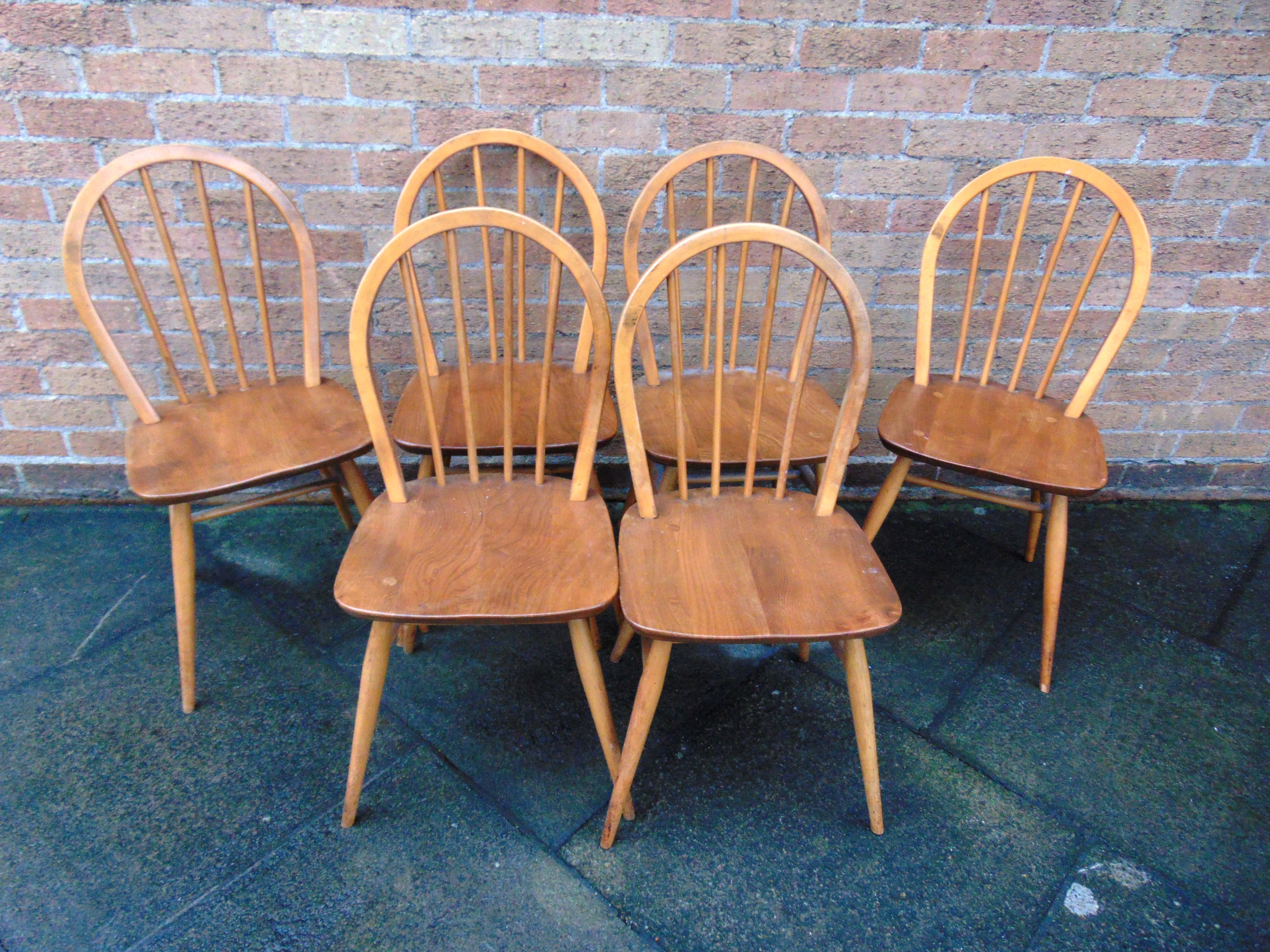 A SET OF SIX ERCOL STICKBACK DINING CHAIRS light elm and beech, stamped ...