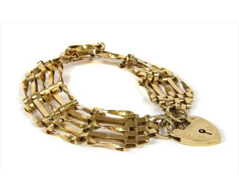 A 9ct gold five row gate bracelet, with alternating plain and twisted bars, to heart shaped padlock clasp and safety chain, L