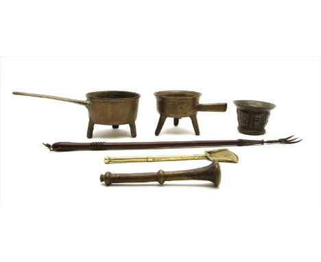 A cast bronze mortar, with a band of masks and columns, 8cm high, and a pestle, a skillet, another and a ladle, and a toastin