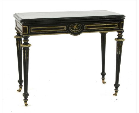 An ebonised tortoiseshell and gilt metal and brass mounted foldover card table, on turned and fluted legs, the castors stampe