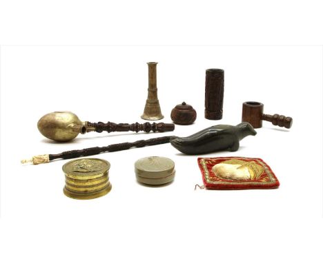 A carved South-East Asian pipe, with a metal bowl, an Inuit carving of a seal, a brass pot and cover, a celadon pot and cover