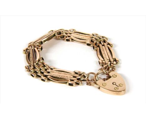 A 9ct gold five row gate bracelet, with curved outer bars to heart shaped padlock clasp and safety chain, 15.71g