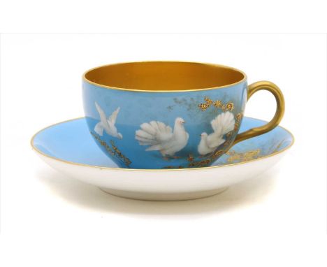 A Royal Worcester powder blue cup and saucer, each decorated with fantail pigeons, and with gilt interior, the saucer signed 