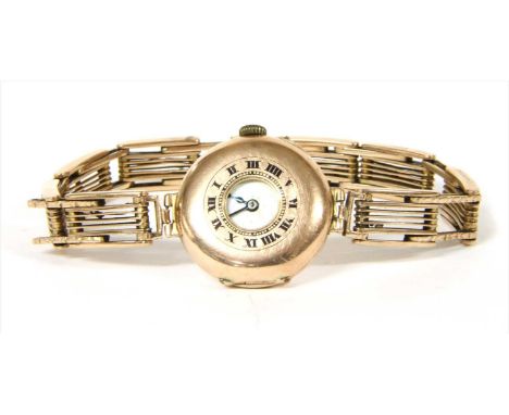 A 9ct gold pin set half hunter style mechanical wristwatch, 29mm diameter, chapter ring with black Roman numerals to the cove