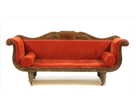 A Regency mahogany sofa , with flame figured and gadroon moulded back, scroll ends and on gadroon moulded legs, 205cm wide, 6