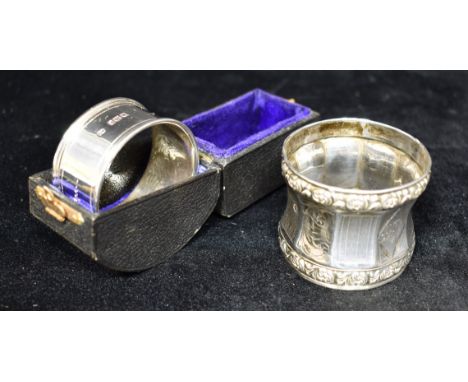 A FRENCH SILVER SERVIETTE RING The faceted design with alternating engine turned and scroll pattern facets with applied borde