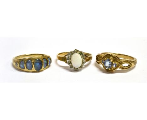 THREE 9CT GOLD DRESS RINGS Comprising an oval type 5 stone with tiny diamond shoulders, an opal and very small diamond cluste