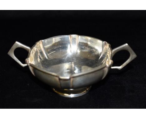 AN ARTS AND CRAFTS DESIGN SMALL TWO HANDLED BOWL The cushion shaped bowl plain with six raised strap form sections and two an