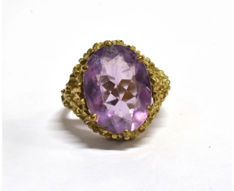 AN AMETHYST SINGLE STONE DRESS RING  the amethyst approx. 16 x 12mm to an organic design head, maker's stamp SJ, no hallmark,