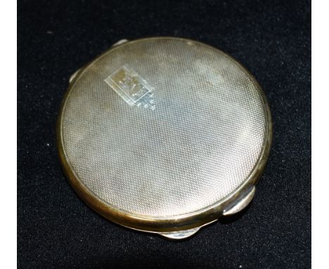 A SILVER COMPACT  The round compact with engraved engine turned decoration to lid, engraved cartouche Beryl 10-4-50, hallmark