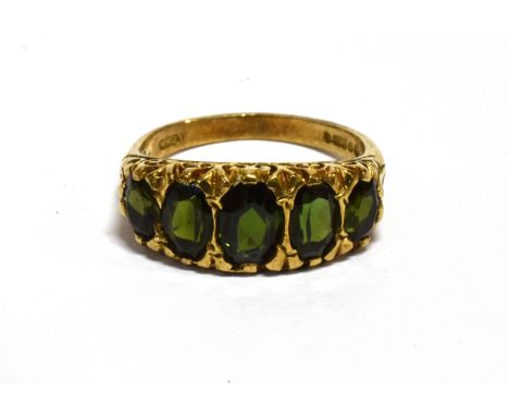 A GREEN TOURMALINE FIVE STONE 9CT GOLD RINGThe five graduating oval cut green stones, assessed as tourmaline, centre stone 7m