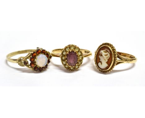 THREE 9CT GOLD DRESS RINGS  Comprising an opal and garnet cluster, size Q, an amethyst and white stone cluster, size N 1/2; a