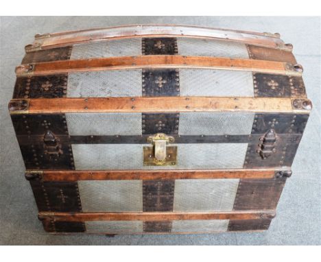 AN AMERICAN METAL BOUND DOME TOP TRAVELLING TRUNK the fitted interior with lift-out compartments and trays, stencilled to bas