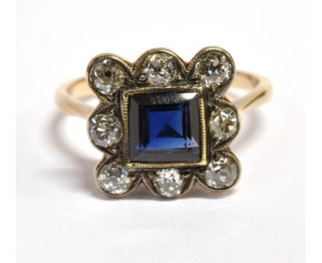 A LATE 19TH/EARLY 20TH CENTURY SAPPHIRE AND DIAMOND SQUARE CLUSTER RING The central square cut sapphire approx. 6.3 mm square