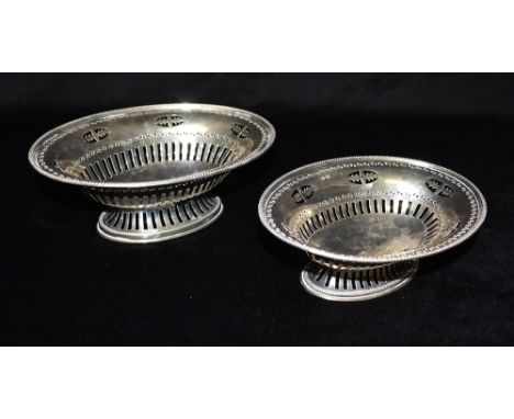 A PAIR OF SILVER BON BON DISHES One large, one small of oval shape pierced decoration on pierced pedestal base, 20 cms and 17