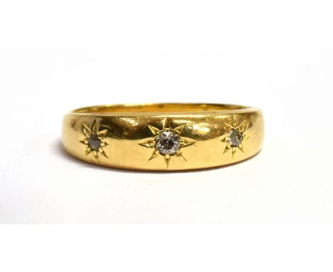 AN 18CT GOLD DIAMOND SET BAND RING Three small round cut diamonds gypsy star set to 18ct gold band size M, gross weight appro