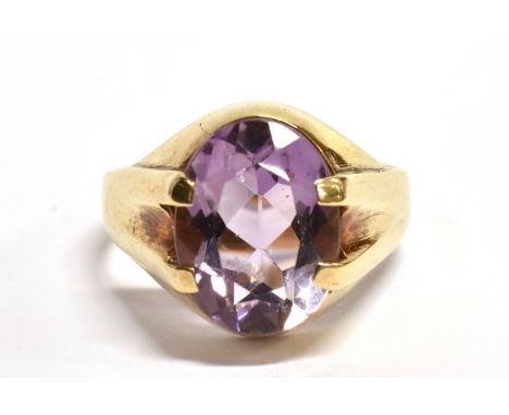 AN AMETHYST SINGLE STONE SIGNET RING The oval cut amethyst approx. 12mm x 9mm, claw set to a hallmarked 9ct gold shank, size 