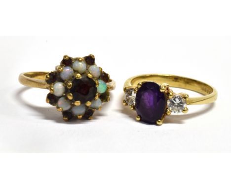 TWO GARNET SET 9CT GOLD DRESS RINGS  Comprising a garnet and white three stone ring, size M; and a garnet and opal cluster, s