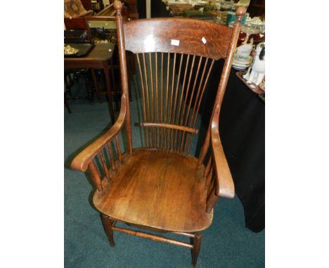A late 19th century oak comb back open armchair.