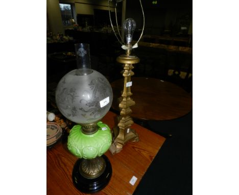A late Victorian oil lamp with light green opaque glass reservoir, along with a 17th century style gilt wood table lamp (unfi