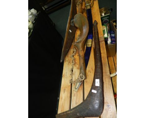 An Australian hardwood Leangle club, boomerang and parrying shield,along with a parasol, a reproduction Indian sword in purpl