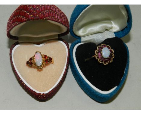 Two 9ct gold opal and red stone set dress rings.