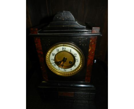 A Victorian black slate and rouge marble eight day mantle clock.