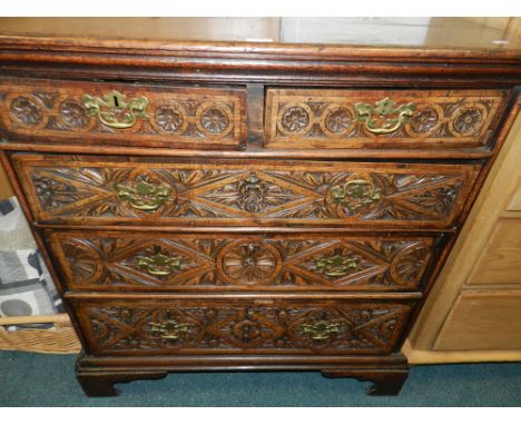 An 18th century oak chest of two short over three long graduated drawers raised on shaped bracket feet, the drawer fronts lat