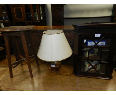 A small oak circular occasional table, wall hanging small corner cabinet with astragal glazed door, a brass table lamp and th