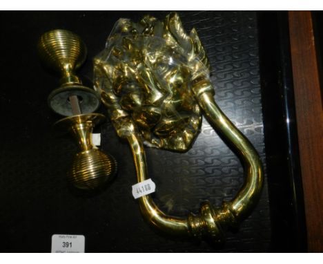 A brass lion mask door knocker 20th century, along with a double sided reeded brass door knob.