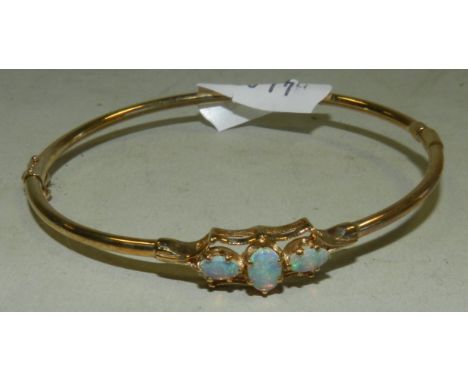 A 9ct gold opal set hinged bangle