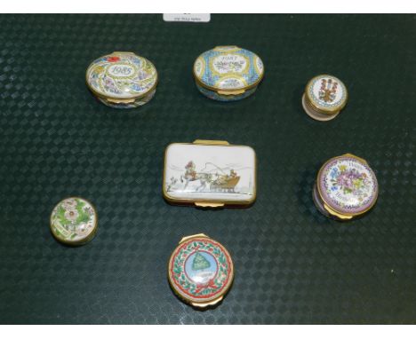 A collection of Halcyon Days enamel pill boxes.