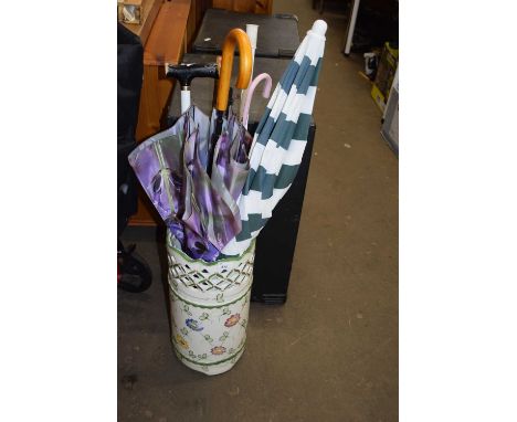 A ceramic stick stand and a quantity of sticks and umbrellas