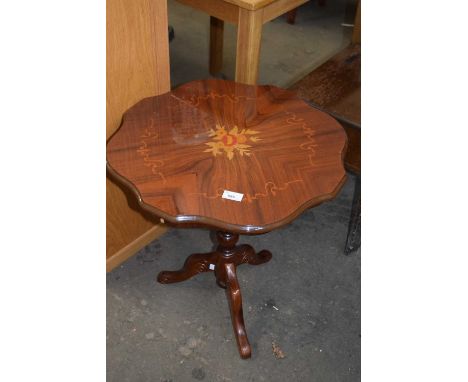 An inlaid tripod table