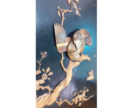 A Japanese Shibayama plaque depicting an eagle about to hunt, carved with inlays of faux ivory and mother of pearl, on ebonis