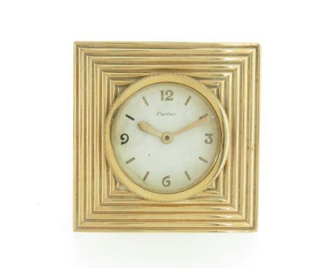 A square gold and gilt metal table clock by Cartier, the front face set in gold, the dial signed Cartier, numbered 09 3992 to