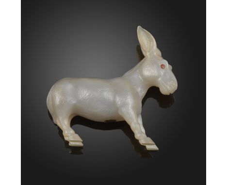 A carved grey hardstone model of a mule, in a stubborn pose, red stone eyes, applied to the underside with a metal disc marke