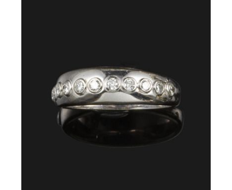 A diamond half-hoop ring, set with eleven round brilliant-cut diamonds in white gold, size O